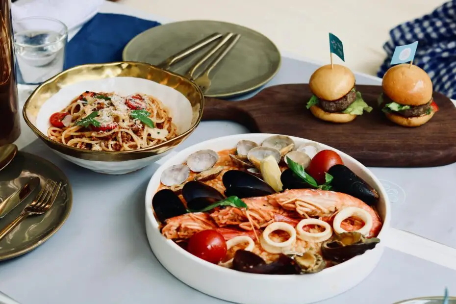 Delicious seafood and pasta dish with mini burgers, ideal for food lovers.